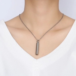 Minimalist silver stainless steel perfume bottle pendant necklace on a female model