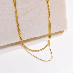 Double-layered gold stainless steel necklace featuring sleek snake and round link chains