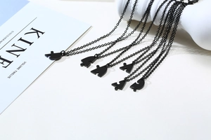 Macro shot of 6-piece matte black puzzle piece heart friendship necklaces for graduates
