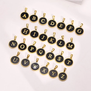 Round 26-letter initial charms in gold finish with black enamel inlays on white background