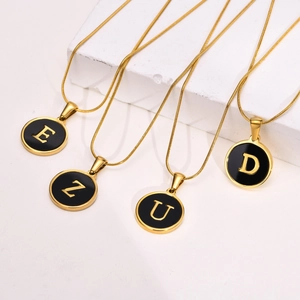 Gold letter pendant necklaces with black enamel E, Z, U, D on sleek snake chains