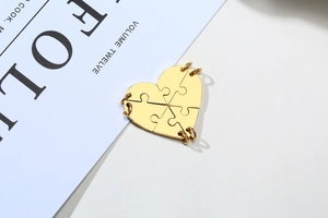 Macro view of four-piece golden heart puzzle pendant for friendship or family necklace