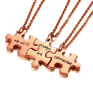 Detailed macro of rose gold puzzle friendship necklaces with connected message engraving