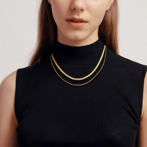 Close-up of double layer gold stainless steel necklace on a model with black sweater