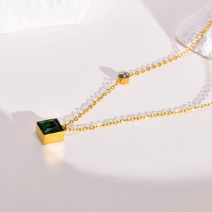 Golden stainless steel necklace featuring a square green zircon pendant and round stone
