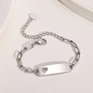 Detailed view of stainless steel kids bracelet with heart cutout and engraved nameplate