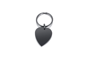Macro detail of minimalist heart shaped metal pendant and key ring in matte black finish