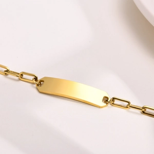 Detail shot of golden stainless steel bracelet with blank bar for custom engraving