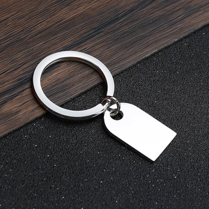 Close-up of polished stainless steel rectangle tag and ring for custom laser engraving
