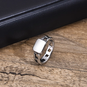 Macro shot of silver stainless steel ring with hollow chain link and flat square top