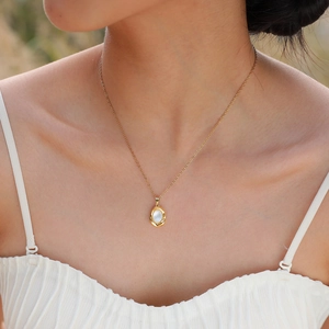 Elegant 18K gold-plated necklace featuring an oval shell pendant on a delicate chain