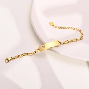 Detail of gold stainless steel kids bracelet with heart cutout and blank engravable plate
