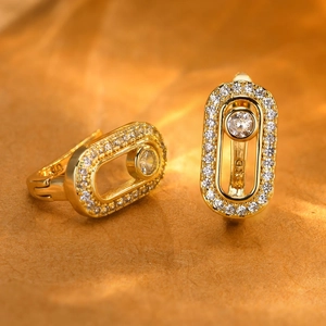 Macro shot of 18K gold plated oval earrings with center moving diamond and zircon stones
