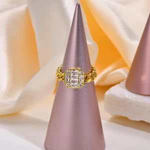 Close-up of gold zircon chain ring on purple display stand with silk background