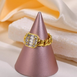 Detail of gold Cuban chain ring featuring sparkling zircon baguette and round stones