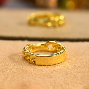 Detailed close-up of a golden Cuban link chain ring with a polished rectangular plaque