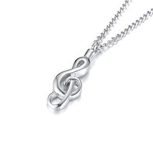 Macro shot of polished stainless steel musical note pendant with reflective finish
