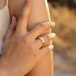Minimalist gold chain link ring with a polished rectangular plate shown on a hand