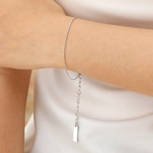 Macro shot of minimalist gold square chain bracelet with adjustable link on model wrist