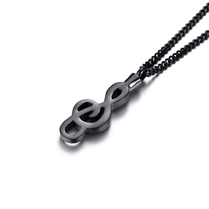 Macro shot of a black stainless steel musical note G-clef pendant on a matching chain