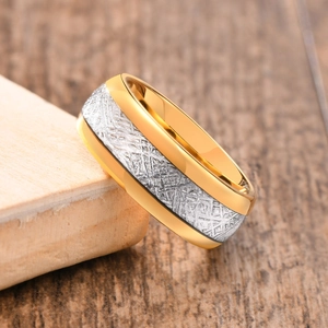 Macro shot of 8mm gold and silver tungsten ring with unique meteorite texture inlay