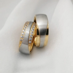 Macro shot of two-tone stainless steel couple rings with cubic zirconia pave setting
