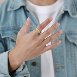 8mm two-tone tungsten ring with gold edges and silver woven texture inlay on finger