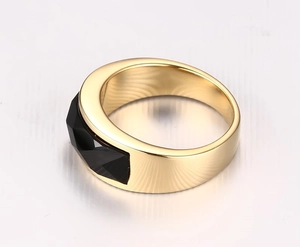 Detailed close-up of a gold-plated stainless steel ring featuring a black faceted onyx gemstone