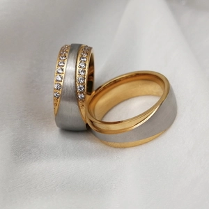 Macro shot of two-tone couple rings with brushed silver finish and double-row zircon inlay