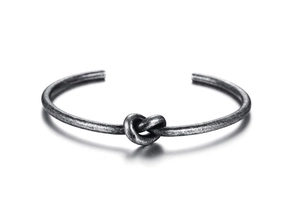 Close-up of titanium steel knot open bangle showing vintage silver textured finish