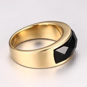 Polished gold-tone wide band ring featuring a multifaceted black onyx gemstone inlay