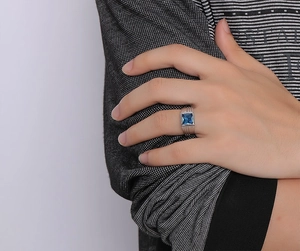 Detail of square blue sapphire ring with grooved stainless steel band for men