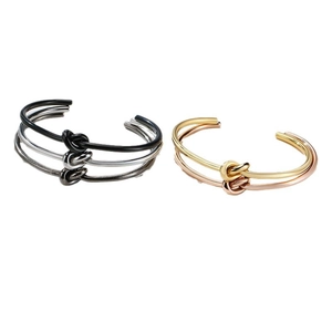Minimalist knotted cuff bracelet in gold, silver, and rose gold polished titanium steel