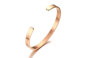 Detailed view of a rose gold C-shaped cuff bracelet with polished and brushed metal finish