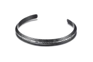 Close-up of retro 6mm stainless steel open cuff with intricate geometric engravings