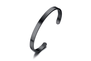 Detail of 6mm matte black stainless steel C-shape cuff bracelet showing brushed metal texture