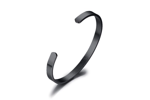 Close-up of 6mm matte black stainless steel C-shaped cuff bracelet with a brushed finish