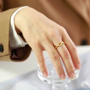 Chic gold stainless steel cuban chain ring worn by a model for a modern fashion look