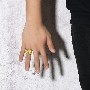 Golden stainless steel signet ring with vintage anchor emblem on a round face for men