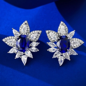 Classic S925 silver stud earrings featuring oval blue corundum and floral halo crystals