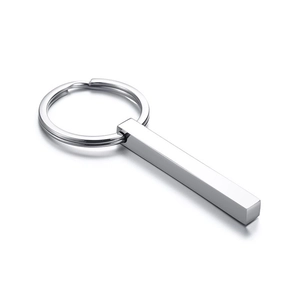 Close-up of polished stainless steel bar keychain pendant with reflective silver finish