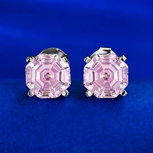 Classic pink octagon cut stud earrings with four-prong silver settings on blue velvet