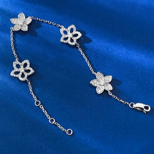 S925 silver hollow floral bracelet with pavé diamonds on elegant dark blue silk background