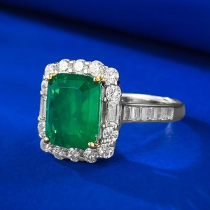 Macro view of emerald-cut green gemstone ring with baguette-cut side diamonds