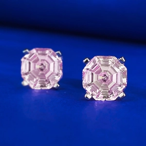 Detailed macro shot of pink octagon step-cut zircon stud earrings with silver 4-prong setting