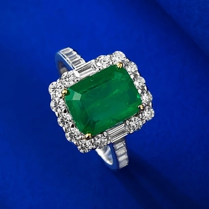 S925 silver emerald cut gemstone ring with halo diamonds on blue velvet