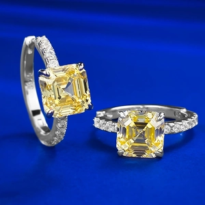 Gros plan de créoles en argent S925 avec pierre carrée jaune éclatante et pavage de diamants
