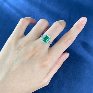 S925 sterling silver ring featuring a 2-carat emerald cut green gemstone with halo diamonds
