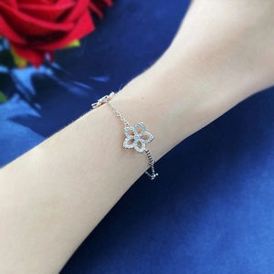 Detail of S925 silver flower bracelet featuring hollow petals and sparkling zircon pavé