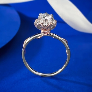 Two-tone 925 silver bouquet ring with crown-set diamond on elegant blue background